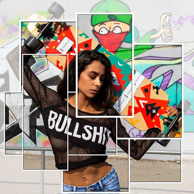 A stylish woman with a skateboard poses against graffiti art in this trendy urban fashion shot.
