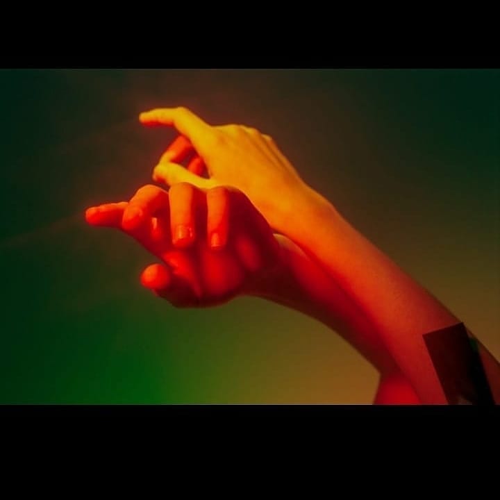 An intimate close-up featuring hands bathed in warm, dreamy light, ideal for well-being and personal care campaigns.