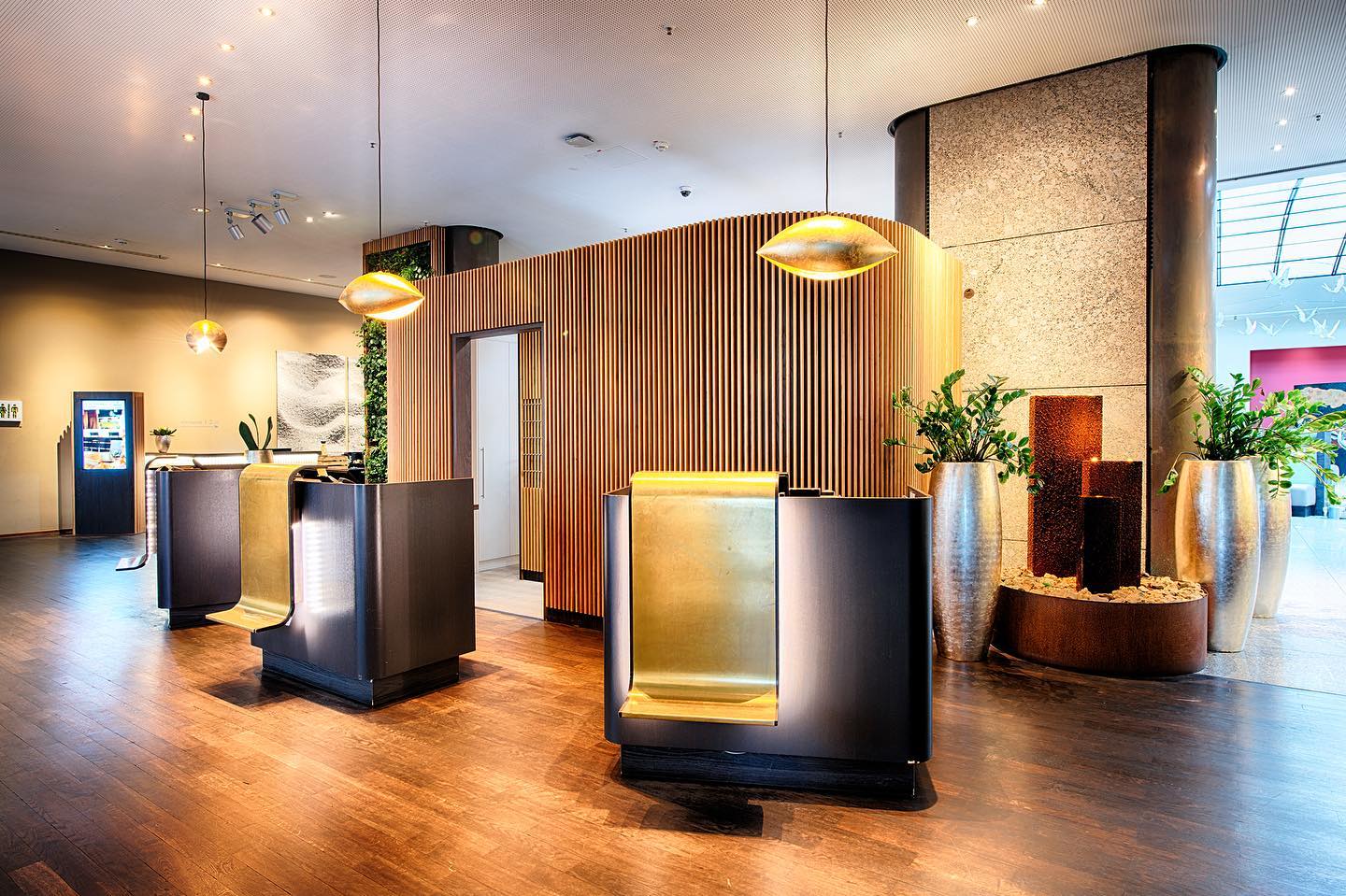 An elegant hotel lobby features a modern reception area with warm lighting and sophisticated design elements.