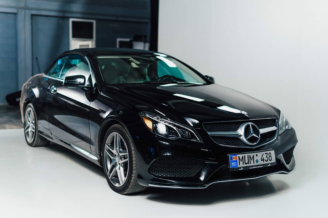 A sleek black Mercedes-Benz coupe showcases luxury and style in a studio setting.