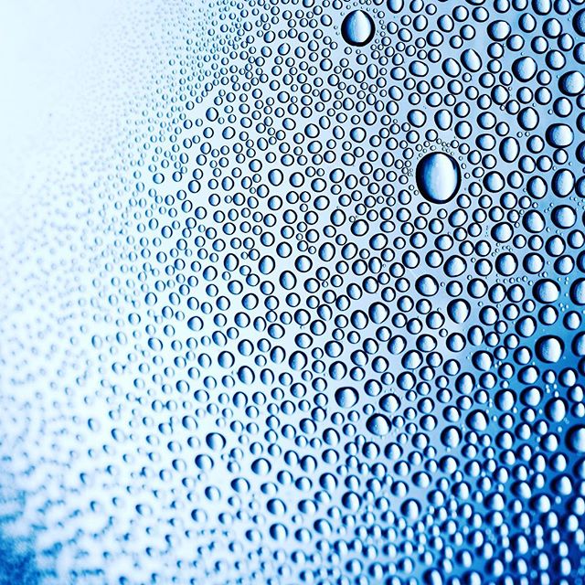 A close-up shows water droplets clinging to a blue surface, highlighting the beauty of condensation.