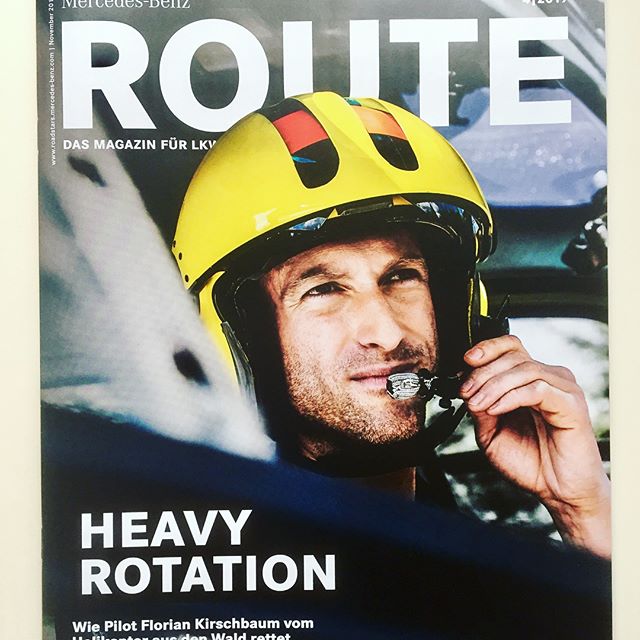 A pilot in a yellow helmet speaks into a headset, promoting Mercedes-Benz's "Route" magazine.