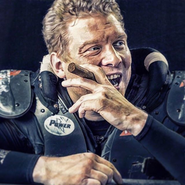 A confident football player celebrates with a cigar, embodying success and sportsmanship.