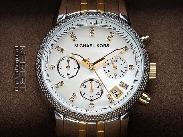 A close-up showcases a Michael Kors watch, highlighting its elegant design and luxury appeal.