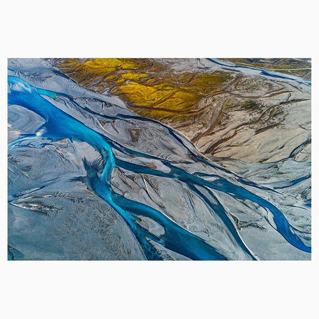 Aerial view of a braided river in Iceland showing natural patterns and textures from above.