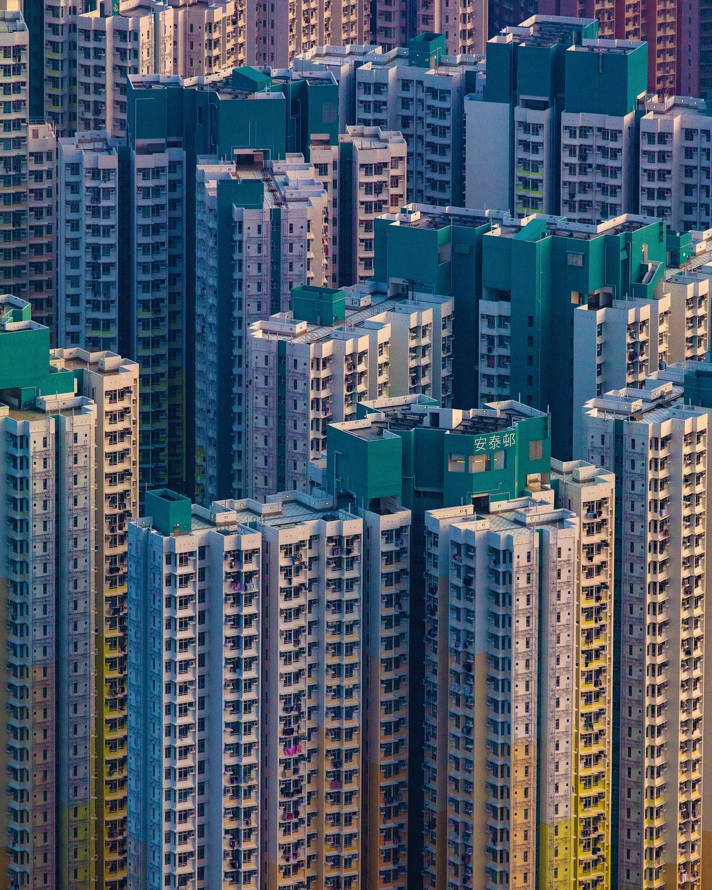 A dense cityscape of high-rise apartment buildings in Hong Kong showcases urban architecture and residential density.