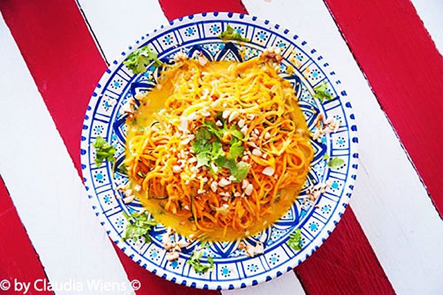 A vibrant butternut squash pasta dish with nuts, perfectly styled for a food blog or website.
