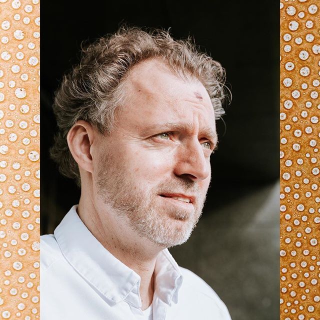 Portrait of a pensive man looking away in natural light, suitable for wellness or lifestyle content.