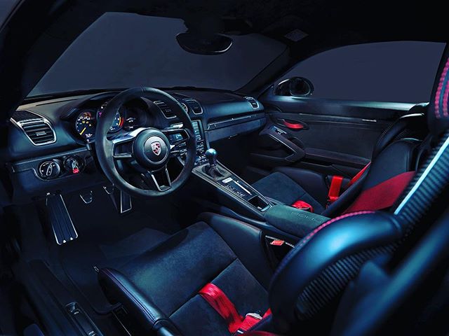 A luxurious Porsche sports car interior featuring a sleek steering wheel and premium design.