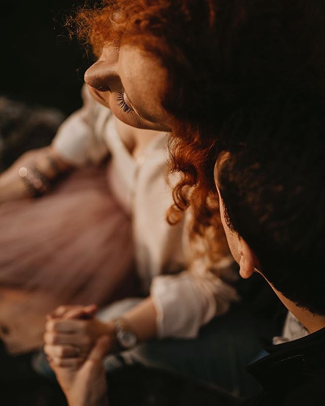 An intimate moment of a couple holding hands, bathed in soft, warm light, showcasing love and connection.