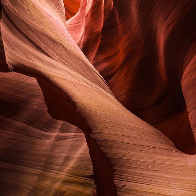 Abstract view of Antelope Canyon's red rock formations, showcasing its natural beauty and geological wonders.