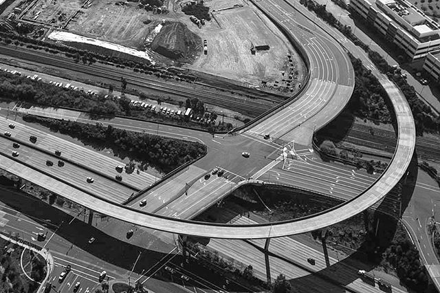 Aerial view of a complex highway interchange showcasing modern transportation infrastructure in an urban setting.