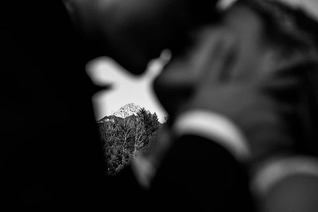 A black and white mountain landscape is reflected in a blurred object, creating an artistic and abstract composition.