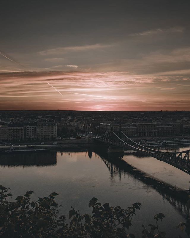 A scenic view of the Chain Bridge in Budapest, Hungary at sunset over the Danube River. 