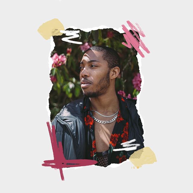 A stylish man in a floral shirt and jacket poses outdoors in natural light.