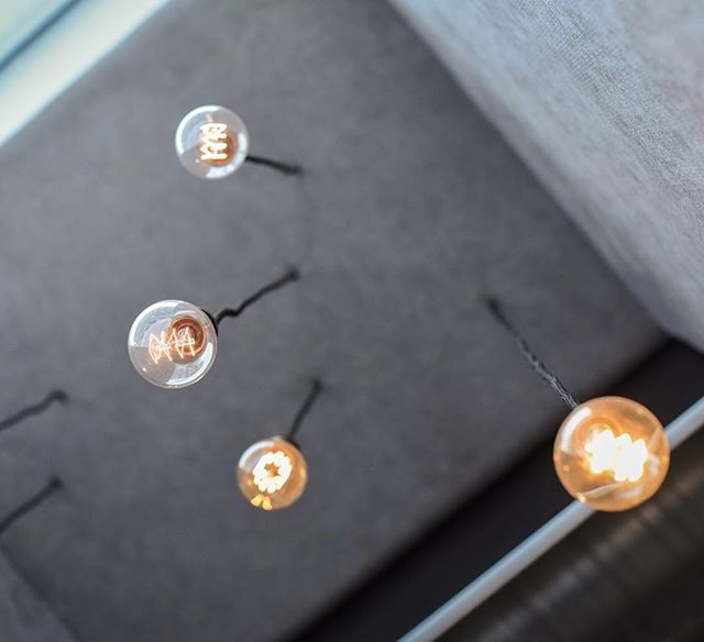 Modern light bulbs hang from the ceiling, providing a warm and inviting ambiance.