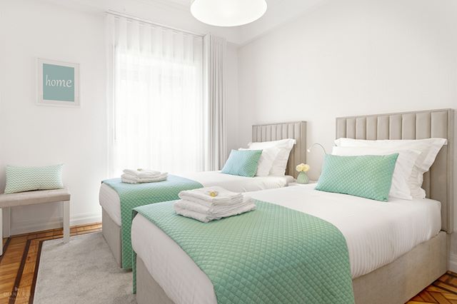 Bright and clean bedroom with two beds, perfect for a relaxing stay in a modern home or hotel.