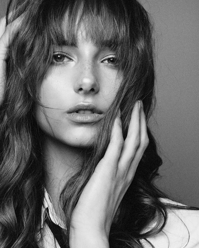 A stunning black and white portrait of a woman with soft lighting and a dreamy mood.