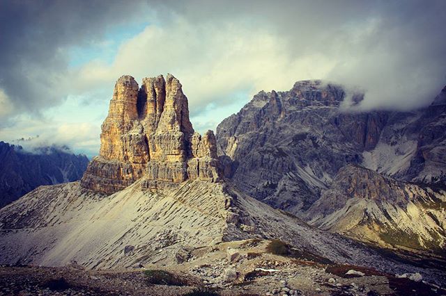 Scenic view of the Tre Cime di Lavaredo, a mountain range in the Dolomites, featuring unique rock formations and tranquil atmosphere.