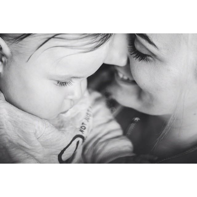 A tender moment between a mother and her baby, showcasing love and connection.