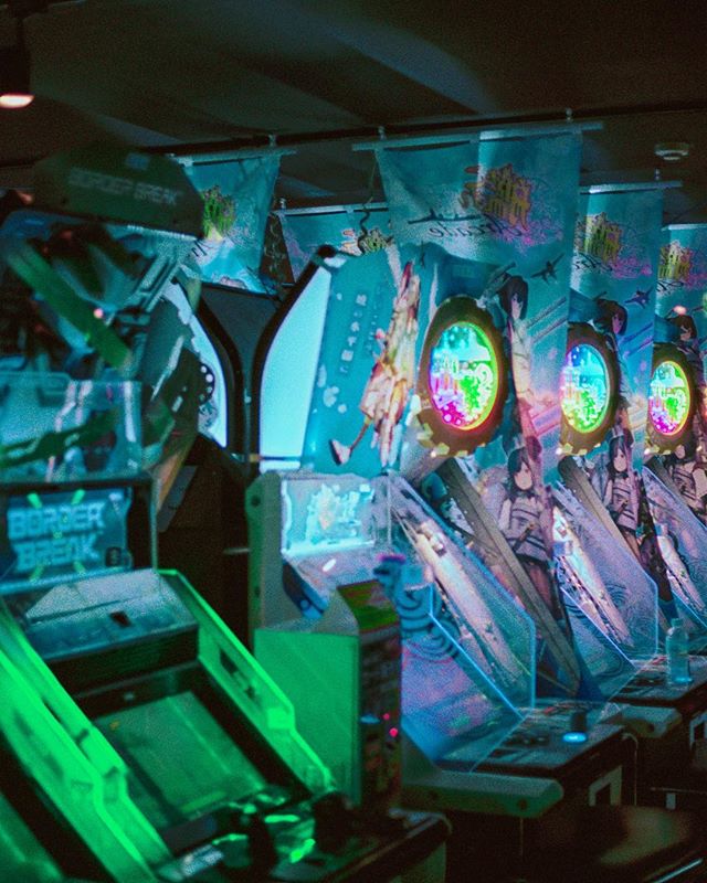 A vibrant row of Border Break arcade machines lit with neon lights evokes a retro, cyberpunk gaming experience.