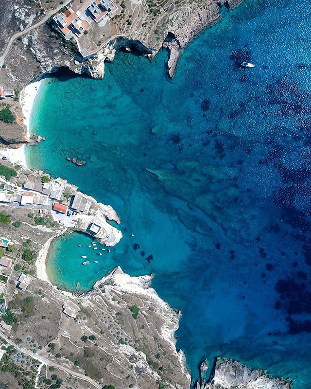 Aerial view of a stunning coastline with turquoise waters, white cliffs, and a small beach perfect for a peaceful getaway.