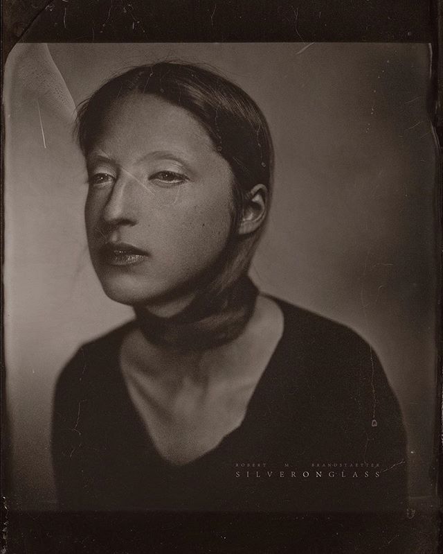 Monochrome portrait of a young woman with a choker necklace, captured with soft light and a vintage style.