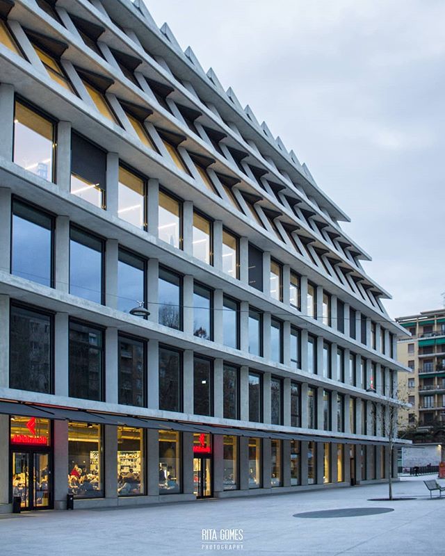 Modern architectural building exterior with geometric details, promoting urban design and property marketing.