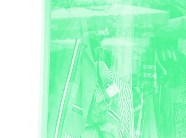 Rack of vintage clothing in a shop window, creating a nostalgic, dreamy atmosphere for fashion and retail marketing.