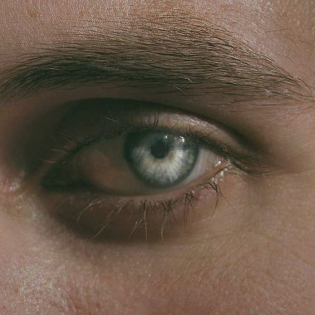 A close-up image showcasing a serene human eye with a dreamy and calm aesthetic.