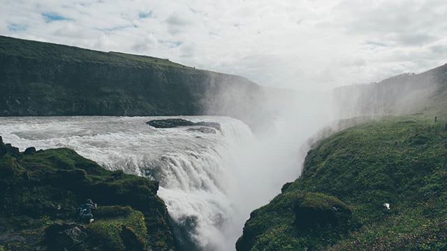 A scenic shot of Gullfoss waterfall in Iceland, showcasing its powerful flow and surrounding natural beauty.