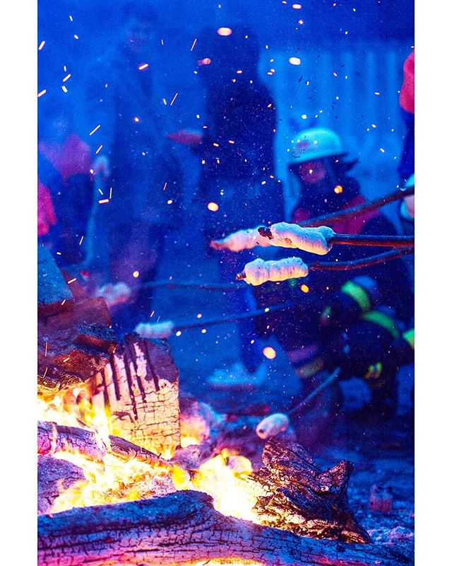 People roast marshmallows over a bonfire, creating a warm and inviting scene perfect for social media campaigns.