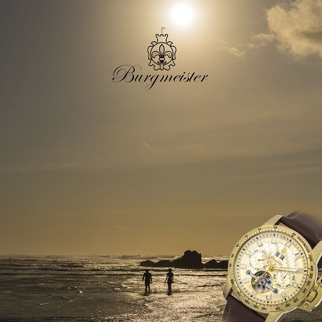 A couple walks on the beach at sunset in this watch advertisement.