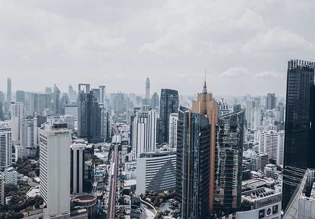 A cityscape showcases modern architecture under a cloudy sky, perfect for urban themes and marketing campaigns.