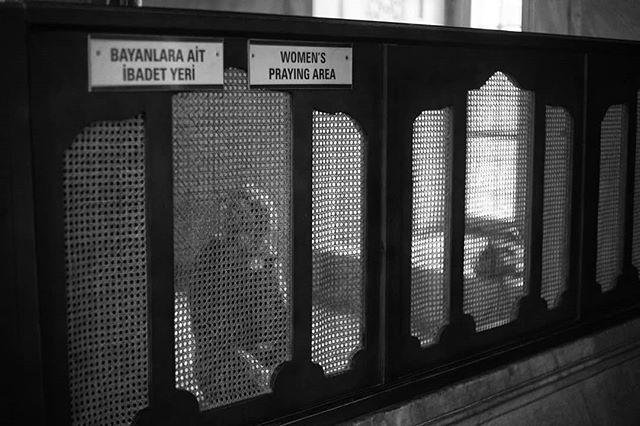 A black and white shot of the women's praying area sign in a mosque.