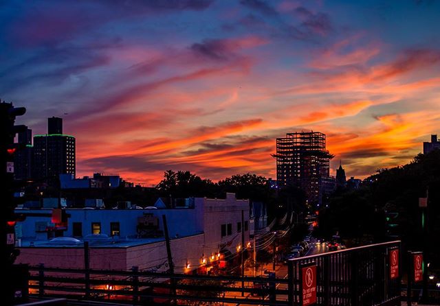 A beautiful cityscape at sunset with vibrant colors in the sky.