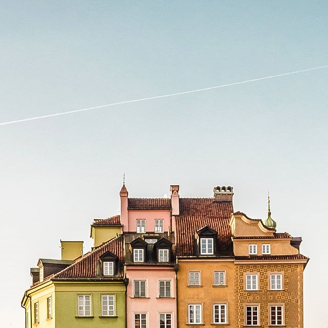 A row of colorful buildings stands against a clear sky, capturing the essence of urban architecture and serene city life.