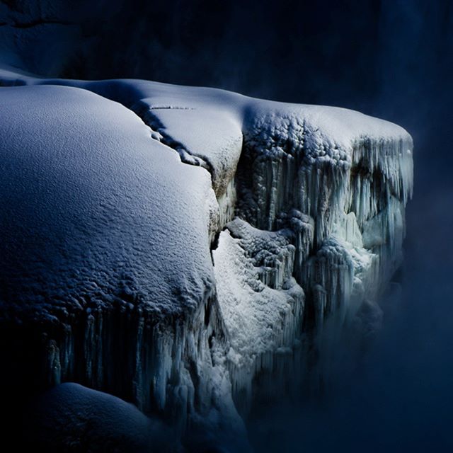A snow and ice-covered cliff face showcases the beauty of winter and a stunning natural landscape.