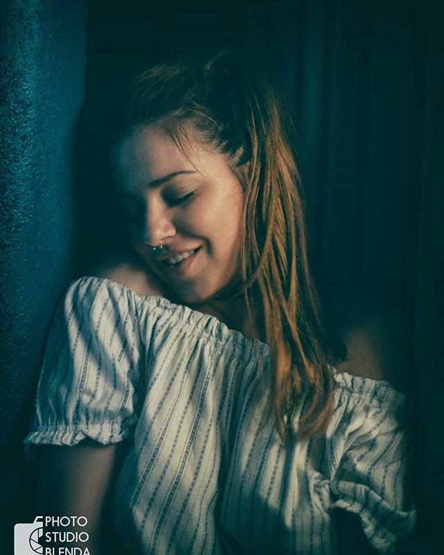 A serene portrait of a smiling woman in soft light, ideal for lifestyle and wellness campaigns.