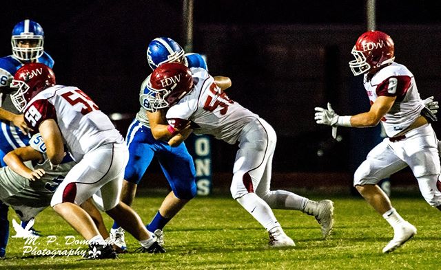 A dynamic shot capturing the intensity of a football game under the lights.