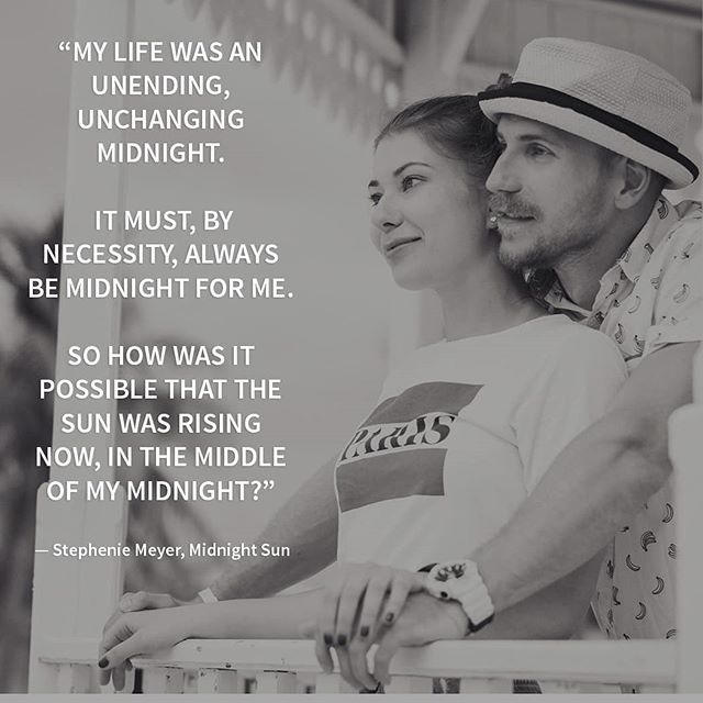 A loving couple in black and white, standing close together.