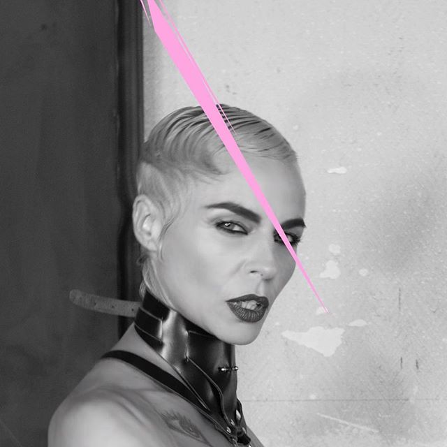 A striking black and white portrait of a woman with a confident gaze and distinctive leather choker.