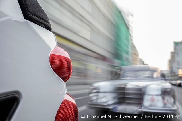 Blurred shot of cars driving in a city street, conveying motion and urban life.