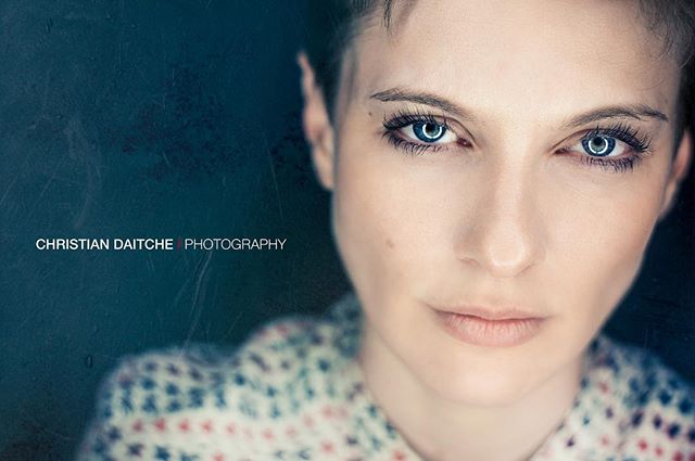 Close-up portrait of a woman with blue eyes in soft light, perfect for a beauty or wellness campaign.