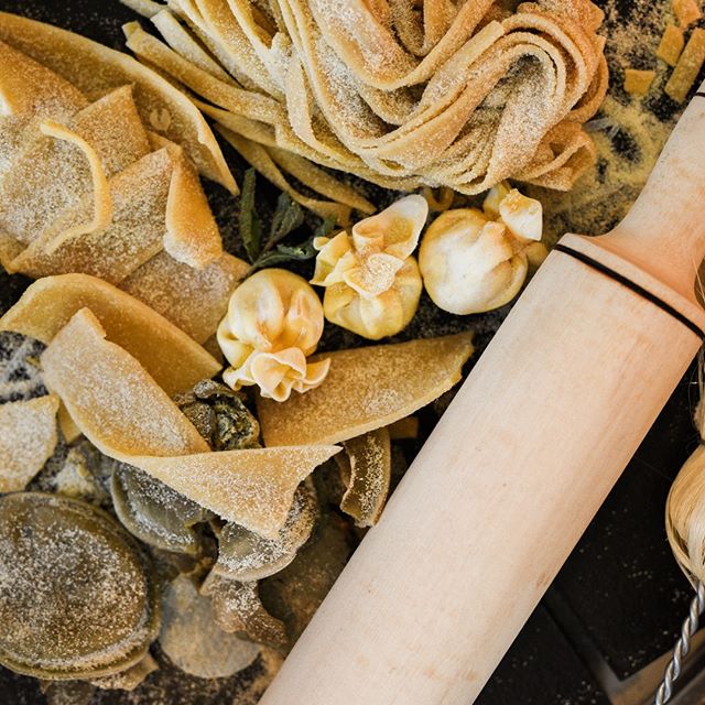 Close-up of fresh pasta with flour and rolling pin, perfect for blog posts and social media.