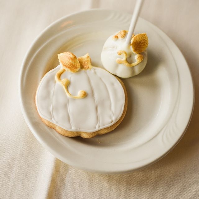 A festive pumpkin cookie and cake pop, perfect for autumn celebrations and sweet treats advertising.