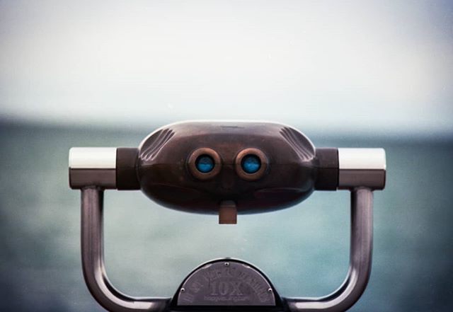 A public viewfinder offers a scenic ocean view, inviting exploration and sightseeing opportunities for travel and tourism.