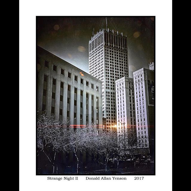 An atmospheric image showcases a cityscape at night, emphasizing the architectural details of the buildings.