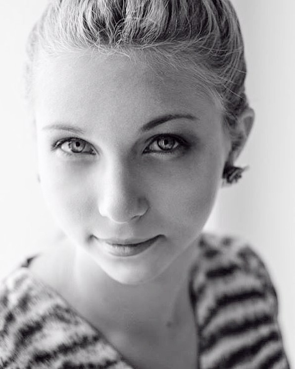 A black and white portrait of a woman with a thoughtful expression.