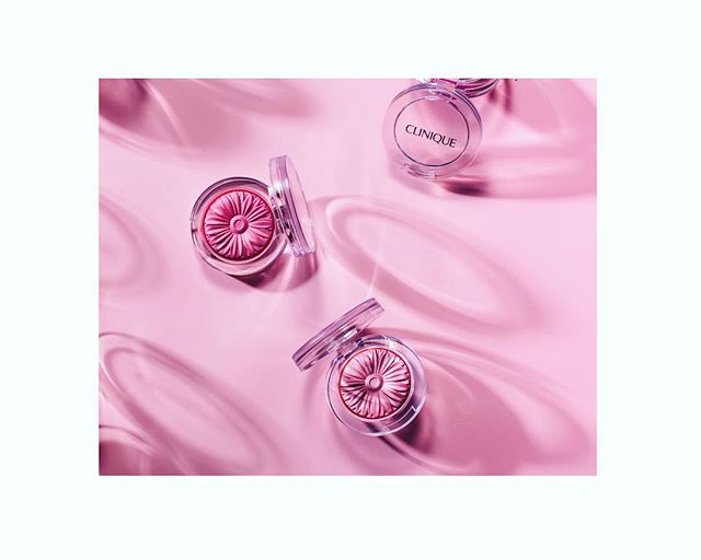 A studio shot of Clinique blush compacts on a pink background for beauty and cosmetics marketing.